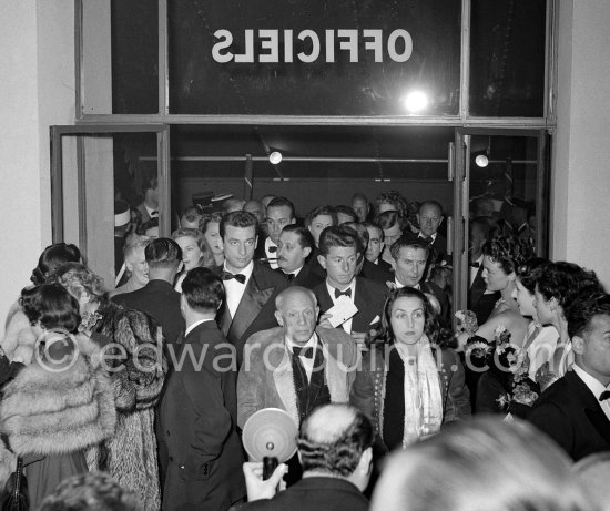 Yves Montand, Paulo Picasso and Pablo Picasso, and Françoise Gilot at the Cannes Film Festival for a screening of "Le salaire de la peur". Françoise Gilot is wearing the Polish coat given to her by Pablo Picasso. Cannes April 16, 1953. - Photo by Edward Quinn