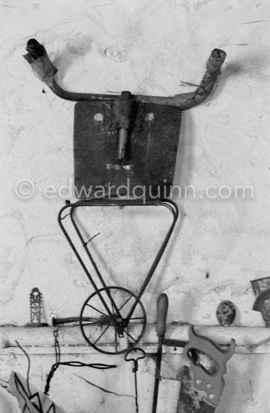 Pablo Picasso mounted various bizarre combinations of scrap iron junk on the wall of his sculpture studio, including this shovel with bicycle handlebars. Studio Le Fournas, Vallauris 1953. - Photo by Edward Quinn