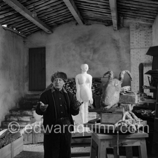 Picasso in his studio Le Fournas. In winter, Picasso wore warm clothes inside the studio, as heating was minimized to prevent the sculptures from. drying too quickly., Vallauris 1953. - Photo by Edward Quinn