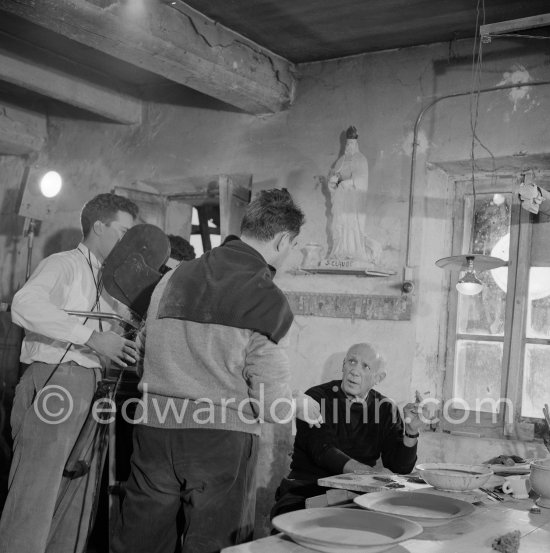 During filming of "Pablo Picasso", director Luciano Emmer, cameraman Giulio Gianini (left) and Pablo Picasso. With a statue of St-Claude Picasso, the patron saint of the potters, whose name was given to his younger son. Madoura pottery, Vallauris 14.10.1953. - Photo by Edward Quinn