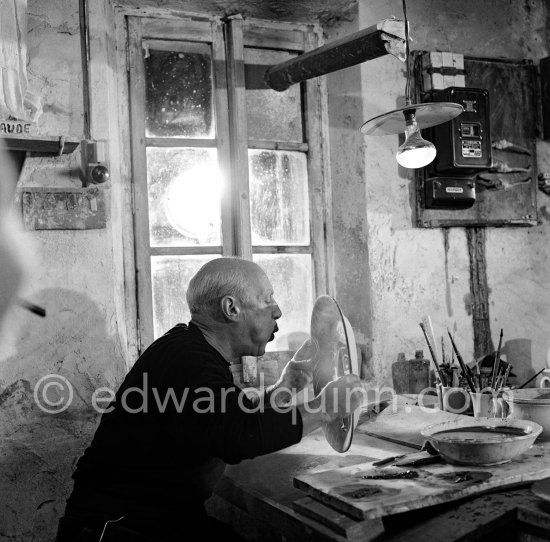 Pablo Picasso blows off surplus clay dust before applying the liquid colors. Madoura pottery, Vallauris 14.10.1953. - Photo by Edward Quinn