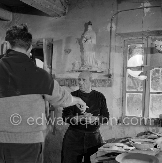 During filming of "Pablo Picasso", directed by Luciano Emmer. With a statue of St-Claude Picasso, the patron saint of the potters, whose name was given to his younger son. Madoura pottery, Vallauris 14.10.1953. - Photo by Edward Quinn