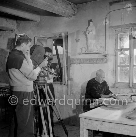 Pablo Picasso during filming of "Pablo Picasso", directed by Luciano Emmer. With a statue of St-Claude Picasso, the patron saint of the potters, whose name was given to his younger son. Madoura pottery, Vallauris 14.10.1953. - Photo by Edward Quinn