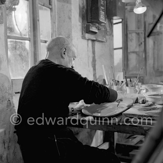 Pablo Picasso working on first version of plate of a woman (Irène Rignault, Madame X), during filming of "Pablo Picasso", directed by Luciano Emmer. Madoura pottery, Vallauris 14.10.1953. - Photo by Edward Quinn