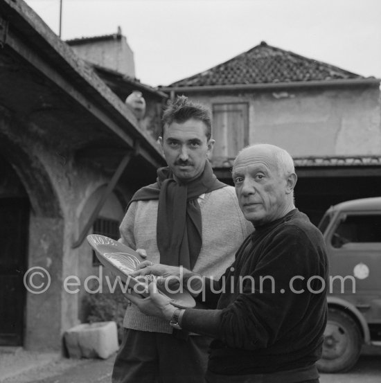 Pablo Picasso and Luciano Emmer with first version of plate of a woman (Irène Rignault, Madame X), during filming of "Pablo Picasso", directed by Luciano Emmer. Madoura pottery, Vallauris 14.10.1953. - Photo by Edward Quinn
