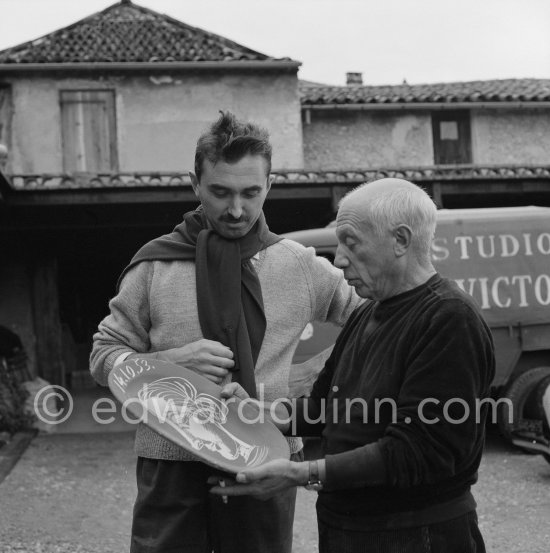 Pablo Picasso and Luciano Emmer with first version of plate of a woman (Irène Rignault, Madame X), during filming of "Pablo Picasso", directed by Luciano Emmer. Madoura pottery, Vallauris 14.10.1953. - Photo by Edward Quinn