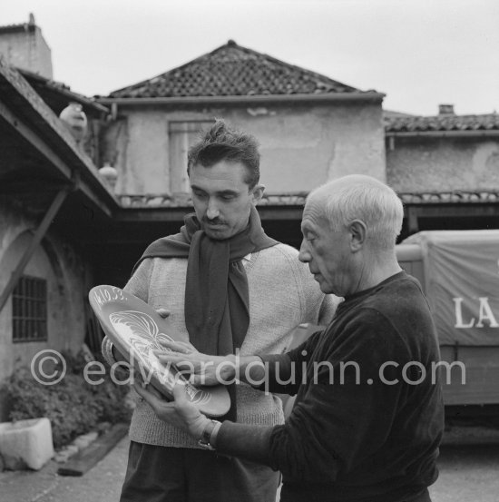 Pablo Picasso and Luciano Emmer with first version of plate of a woman (Irène Rignault, Madame X), during filming of "Pablo Picasso", directed by Luciano Emmer. Madoura pottery, Vallauris 14.10.1953. - Photo by Edward Quinn