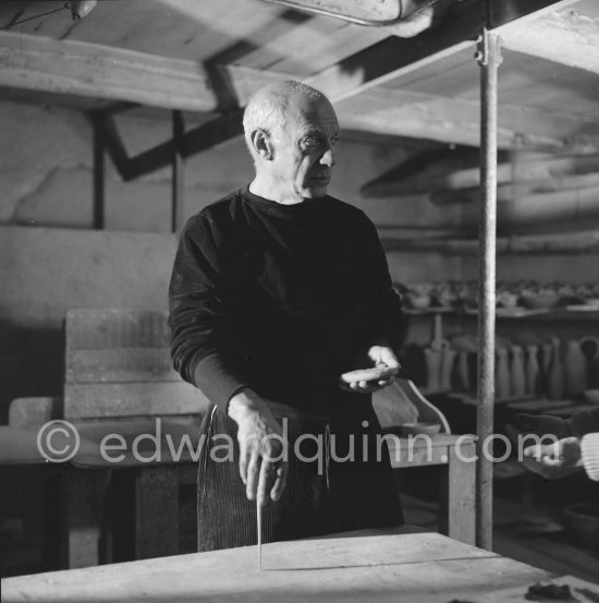 Pablo Picasso would sometimes squeeze a vase before the clay had hardened, molding it into a representational shape. "To give it life," he once said, "I have to wring its neck." Delighted that he could make the clay respond to any fantasy that passed through his mind, he shaped mythologicat figures such as fauns and satyrs, as well as vases representing graceful women, bulls, goats, fish, and above all, owls and doves. Here Pablo Picasso is working on small bird sculpture, Luciano Emmer film. Madoura pottery, Vallauris 14./15.10.1953. - Photo by Edward Quinn