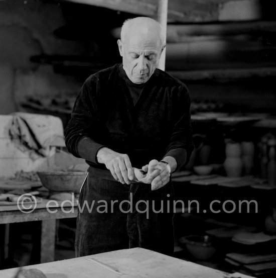 Pablo Picasso would sometimes squeeze a vase before the clay had hardened, molding it into a representational shape. "To give it life," he once said, "I have to wring its neck." Delighted that he could make the clay respond to any fantasy that passed through his mind, he shaped mythologicat figures such as fauns and satyrs, as well as vases representing graceful women, bulls, goats, fish, and above all, owls and doves. Here Pablo Picasso is working on small bird sculpture, Luciano Emmer film. Madoura pottery, Vallauris 14./15.10.1953. - Photo by Edward Quinn