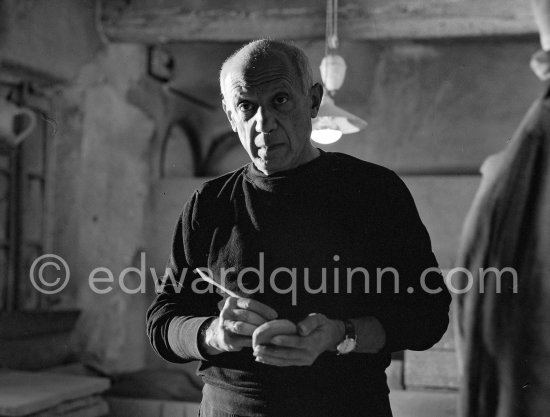 Pablo Picasso would sometimes squeeze a vase before the clay had hardened, molding it into a representational shape. "To give it life," he once said, "I have to wring its neck." Delighted that he could make the clay respond to any fantasy that passed through his mind, he shaped mythologicat figures such as fauns and satyrs, as well as vases representing graceful women, bulls, goats, fish, and above all, owls and doves. Here Pablo Picasso is working on small bird sculpture, Luciano Emmer film. Madoura pottery, Vallauris 14./15.10.1953. - Photo by Edward Quinn