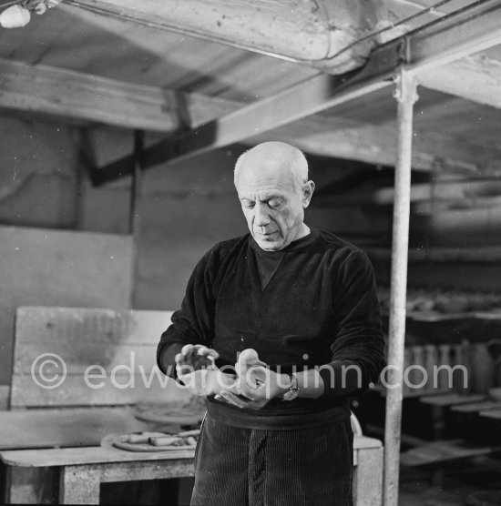 Pablo Picasso would sometimes squeeze a vase before the clay had hardened, molding it into a representational shape. "To give it life," he once said, "I have to wring its neck." Delighted that he could make the clay respond to any fantasy that passed through his mind, he shaped mythologicat figures such as fauns and satyrs, as well as vases representing graceful women, bulls, goats, fish, and above all, owls and doves. Here Pablo Picasso is working on small bird sculpture, Luciano Emmer film. Madoura pottery, Vallauris 14./15.10.1953. - Photo by Edward Quinn