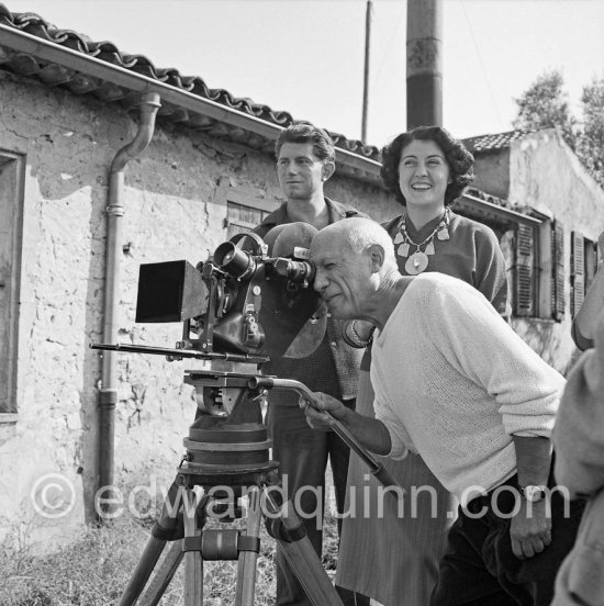 Pablo Picasso checking a camera angle (documentary film of Luciano Emmer). With Paulo Picasso and Madame Paule de Lazerme (she had an affair with Pablo Picasso for some months) who wears a necklace designed by Pablo Picasso. In front of the studio Le Fournas, Vallauris 1953. - Photo by Edward Quinn