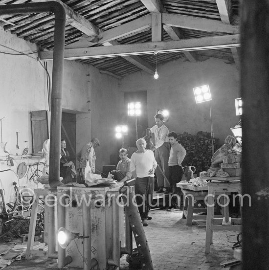 Pablo Picasso and the film team of Luciano Emmer before assembling sculpture "La femme à la clé" on floor. Le Fournas, Vallauris 1953. - Photo by Edward Quinn