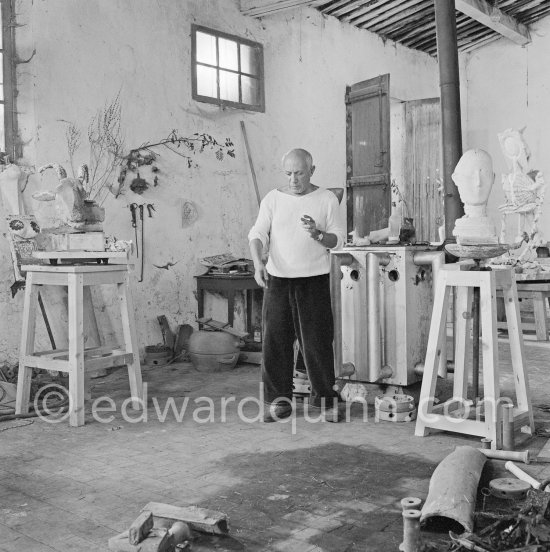 Pablo Picasso working in his sculpture studio Le Fournas making a sculpture figure with odds and ends from his scrap heap. The finished sculpture got the name "La femme à la clé (La Taulière)" ("Woman with a key"). Le Fournas, Vallauris 1953. - Photo by Edward Quinn