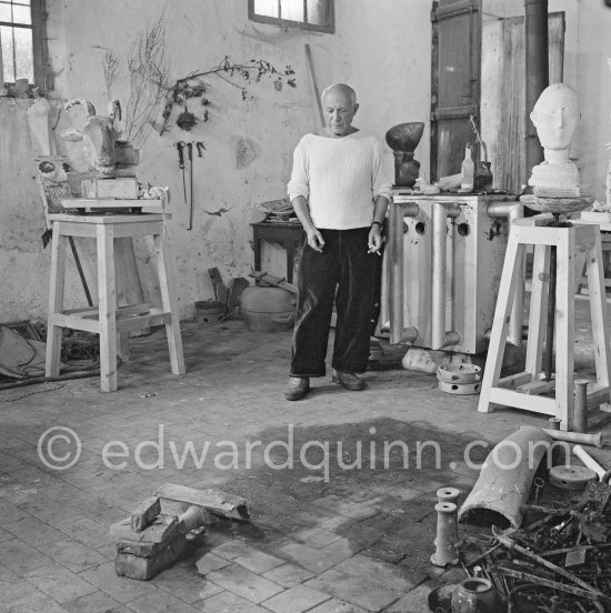Pablo Picasso working in his sculpture studio Le Fournas making a sculpture figure with odds and ends from his scrap heap. The finished sculpture got the name "La femme à la clé (La Taulière)" ("Woman with a key"). Le Fournas, Vallauris 1953. - Photo by Edward Quinn