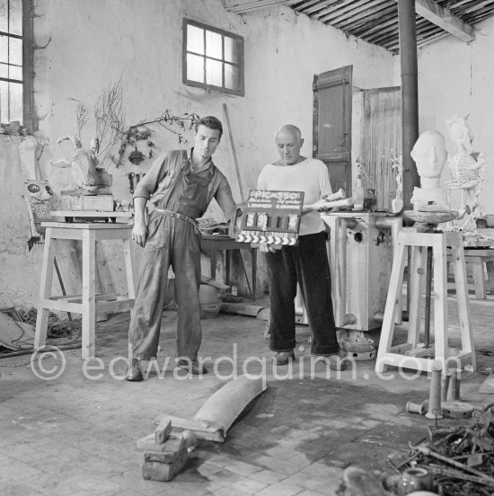 Clapperboard for the film directed by Luciano Emmer. Pablo Picasso working in his sculpture studio Le Fournas making a sculpture figure with odds and ends from his scrap heap. The finished sculpture got the name "La femme à la clé (La Taulière)" ("Woman with a key"). Le Fournas, Vallauris 1953. - Photo by Edward Quinn