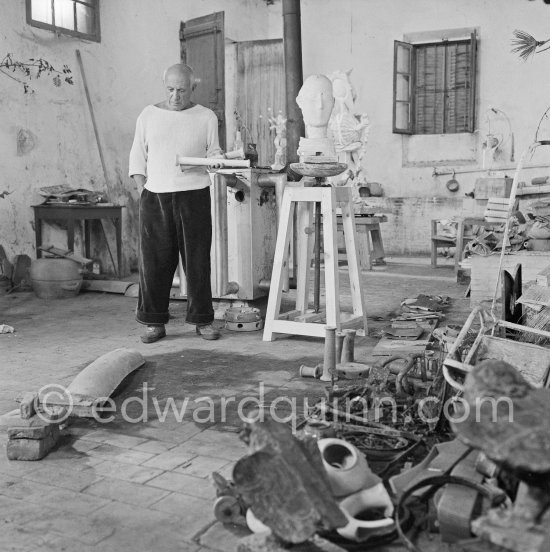Pablo Picasso working in his sculpture studio Le Fournas making a sculpture figure with odds and ends from his scrap heap. The finished sculpture got the name "La femme à la clé (La Taulière)" ("Woman with a key"). Le Fournas, Vallauris 1953. - Photo by Edward Quinn