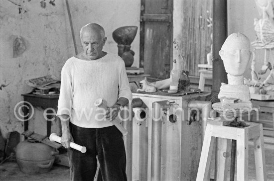 Pablo Picasso working in his sculpture studio Le Fournas making a sculpture figure with odds and ends from his scrap heap. The finished sculpture got the name "La femme à la clé (La Taulière)" ("Woman with a key"). Le Fournas, Vallauris 1953. - Photo by Edward Quinn