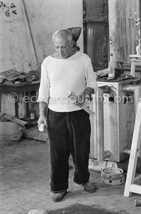 Pablo Picasso working in his sculpture studio Le Fournas making a sculpture figure with odds and ends from his scrap heap. The finished sculpture got the name "La femme à la clé (La Taulière)" ("Woman with a key"). Le Fournas, Vallauris 1953. - Photo by Edward Quinn