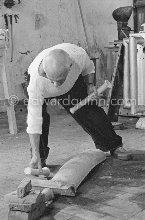 Pablo Picasso working in his sculpture studio Le Fournas making a sculpture figure with odds and ends from his scrap heap. The finished sculpture got the name "La femme à la clé (La Taulière)" ("Woman with a key"). Le Fournas, Vallauris 1953. - Photo by Edward Quinn