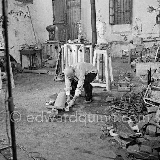 Pablo Picasso working in his sculpture studio Le Fournas making a sculpture figure with odds and ends from his scrap heap. The finished sculpture got the name "La femme à la clé (La Taulière)" ("Woman with a key"). Le Fournas, Vallauris 1953. - Photo by Edward Quinn