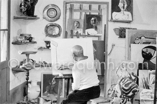 Pablo Picasso doing a charcoal drawing of the view from Le Fournas during filming of Luciano Emmer's documentary. Vallauris 26.6.1953. - Photo by Edward Quinn