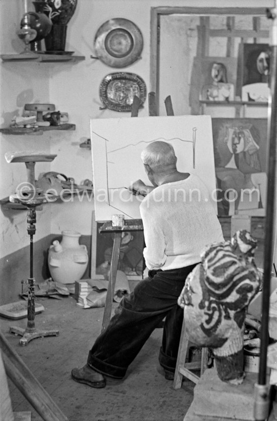 Pablo Picasso doing a charcoal drawing of the view from Le Fournas during filming of Luciano Emmer's documentary. Vallauris 26.6.1953. - Photo by Edward Quinn