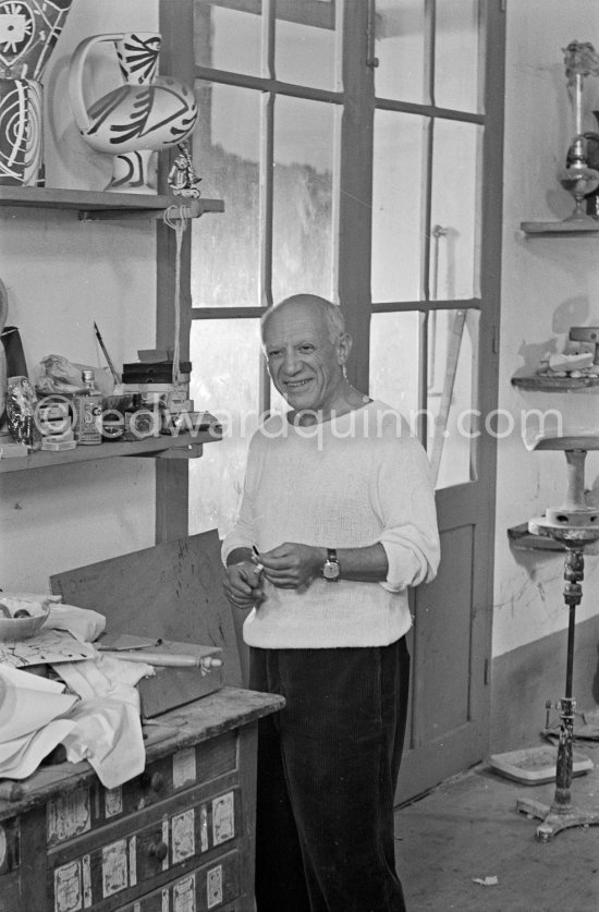 Pablo Picasso in front of a board with ceramics. Le Fournas, Vallauris 1953. - Photo by Edward Quinn