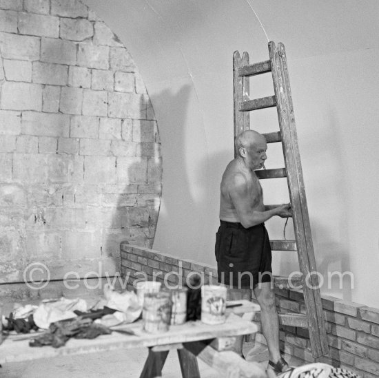 Pablo Picasso working on the "War and Peace study" drawings on the wall of Chapelle de la Paix (or Temple de la Paix) for the documentary film of Luciano Emmer. (The panels of War and Peace of 1952 were away on exhibition). Vallauris 1953. - Photo by Edward Quinn