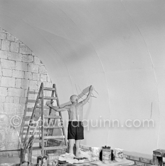 Pablo Picasso working on the "War and Peace study" drawings on the wall of Chapelle de la Paix (or Temple de la Paix) for the documentary film of Luciano Emmer. (The panels of War and Peace of 1952 were away on exhibition). Vallauris 1953. - Photo by Edward Quinn