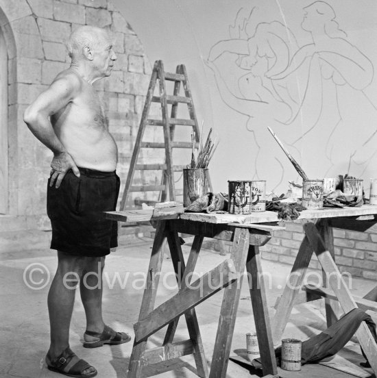 Pablo Picasso working on the "War and Peace study" drawings on the wall of Chapelle de la Paix (or Temple de la Paix) for the documentary film of Luciano Emmer. (The panels of War and Peace of 1952 were away on exhibition). Vallauris 1953. - Photo by Edward Quinn