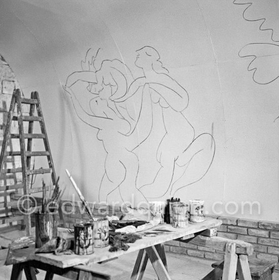 Pablo Picasso working on the "War and Peace study" drawings on the wall of Chapelle de la Paix (or Temple de la Paix) for the documentary film of Luciano Emmer. (The panels of War and Peace of 1952 were away on exhibition). Vallauris 1953. - Photo by Edward Quinn