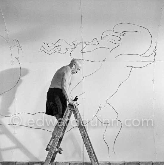 Pablo Picasso working on the "War and Peace study" drawings on the wall of Chapelle de la Paix (or Temple de la Paix) for the documentary film of Luciano Emmer. (The panels of War and Peace of 1952 were away on exhibition). Vallauris 1953. - Photo by Edward Quinn