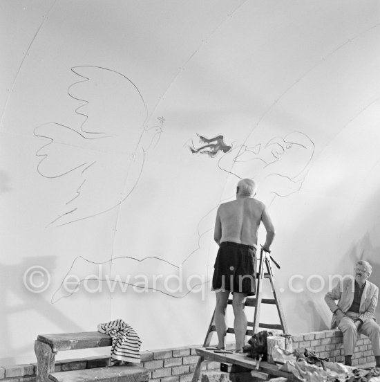 Pablo Picasso working on the "War and Peace study" drawings on the wall of Chapelle de la Paix (or Temple de la Paix) for the documentary film of Luciano Emmer. (The panels of War and Peace of 1952 were away on exhibition). Vallauris 1953. - Photo by Edward Quinn