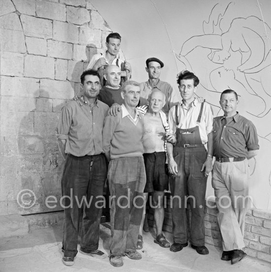 Pablo Picasso with the film crew. Filming of Pablo Picasso working on the "War and Peace study" drawings on the wall of "Chapelle de la Paix." Documentary film by Luciano Emmer. Vallauris 1953. - Photo by Edward Quinn