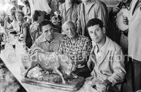 A drink before the bullfight. Pablo Picasso, and the Spanish toreros Jose Montero (right) and Pepe Luis Marca with a statuette of a fighting bull, presented to Pablo Picasso by the toreadors. First Corrida of Vallauris 1954. - Photo by Edward Quinn