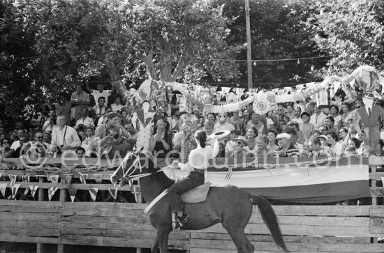 Françoise Gilot, led the toreadors into the arena. On the grandstand singer Yolanda on Pablo Picasso\'s right, Hélène Parmelin, Edouard Pignon, far right Paloma Picasso with her nanny. Corrida Vallauris 1954. - Photo by Edward Quinn