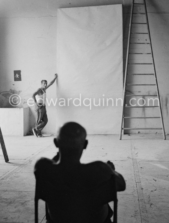 Pablo Picasso working on a bucolic pastoral scene on drawing paper which was to serve as background for the film "Le mystère Picasso". Nice, Studios de la Victorine 1955. - Photo by Edward Quinn