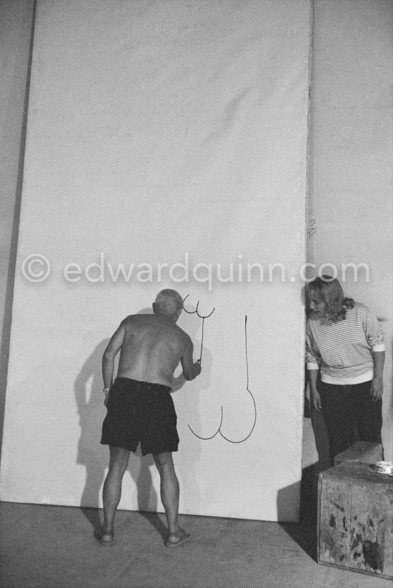 Pablo Picasso working on a bucolic pastoral scene on drawing paper which was to serve as background for the film "Le mystère Picasso". Maya Picasso on the right. Nice, Studios de la Victorine 1955. - Photo by Edward Quinn