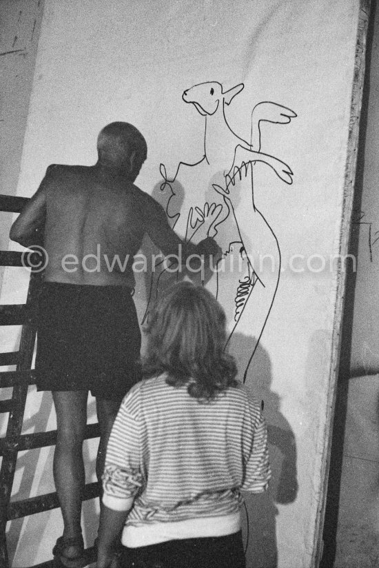 Pablo Picasso working on a bucolic pastoral scene on drawing paper which was to serve as background for the film "Le mystère Picasso". Maya Picasso on the right. Nice, Studios de la Victorine 1955. - Photo by Edward Quinn