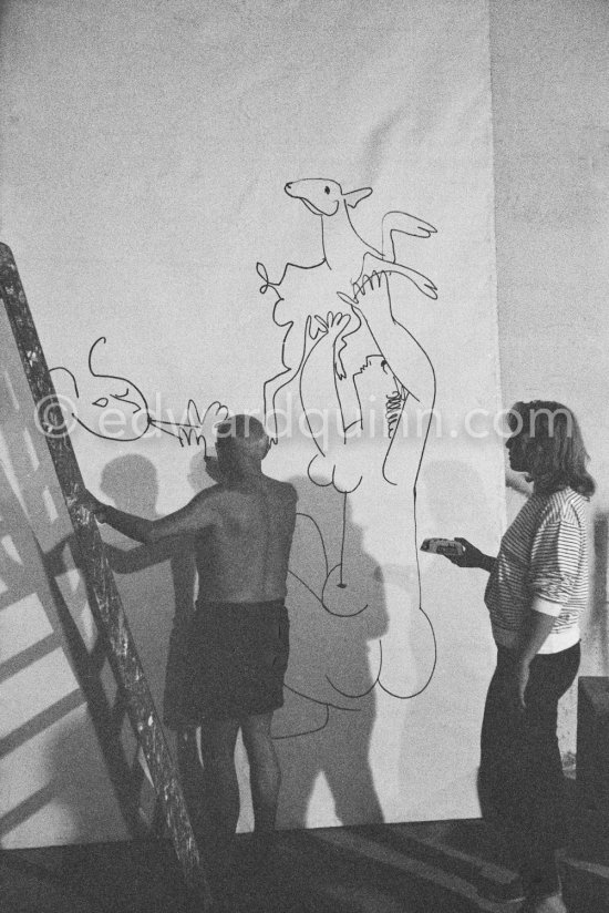 Pablo Picasso working on a bucolic pastoral scene on drawing paper which was to serve as background for the film "Le mystère Picasso". Maya Picasso on the right. Nice, Studios de la Victorine 1955. - Photo by Edward Quinn