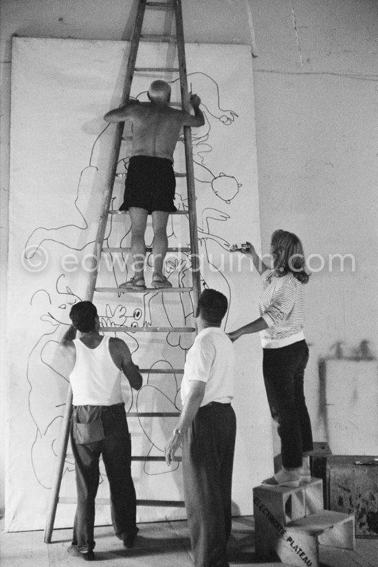 Pablo Picasso working on a bucolic pastoral scene on drawing paper which was to serve as background for the film "Le mystère Picasso". Maya Picasso on the right. Nice, Studios de la Victorine 1955. - Photo by Edward Quinn