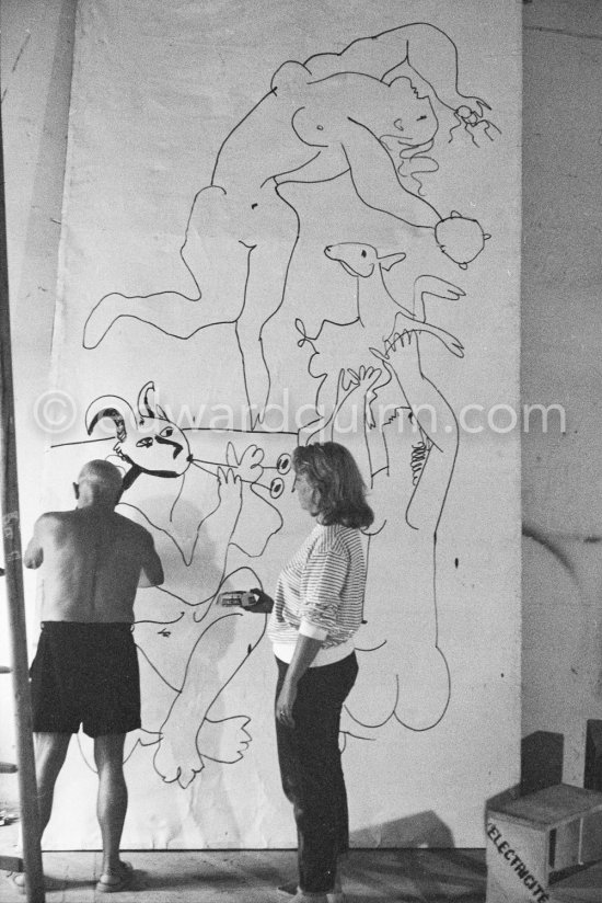 Pablo Picasso working on a bucolic pastoral scene on drawing paper which was to serve as background for the film "Le mystère Picasso". Maya Picasso on the right. Nice, Studios de la Victorine 1955. - Photo by Edward Quinn