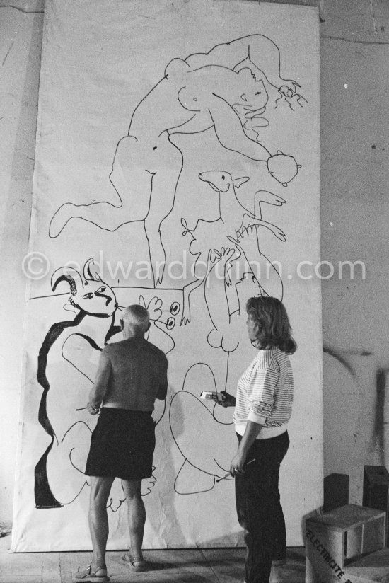 Pablo Picasso working on a bucolic pastoral scene on drawing paper which was to serve as background for the film "Le mystère Picasso". Maya Picasso on the right. Nice, Studios de la Victorine 1955. - Photo by Edward Quinn