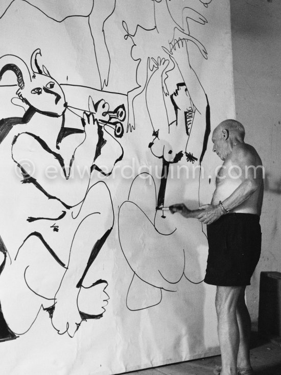 Pablo Picasso working on a bucolic pastoral scene on drawing paper which was to serve as background for the film "Le mystère Picasso". Nice, Studios de la Victorine 1955. - Photo by Edward Quinn