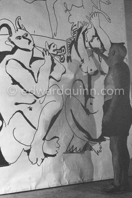 Pablo Picasso working on a bucolic pastoral scene on drawing paper which was to serve as background for the film "Le mystère Picasso". Nice, Studios de la Victorine 1955. - Photo by Edward Quinn