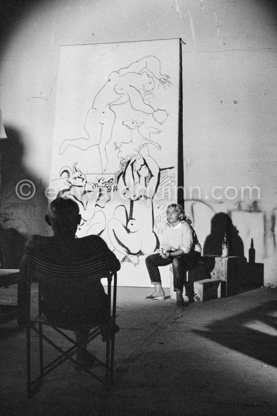 Pablo Picasso working on a bucolic pastoral scene on drawing paper which was to serve as background for the film "Le mystère Picasso". Maya Picasso on the right. Nice, Studios de la Victorine 1955. - Photo by Edward Quinn