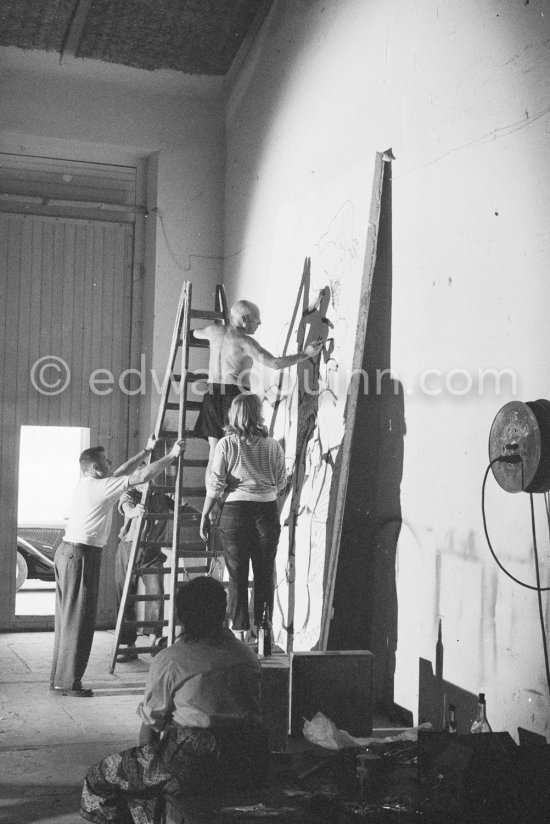 Pablo Picasso working on a bucolic pastoral scene on drawing paper which was to serve as background for the film "Le mystère Picasso". Maya Picasso on the right. Nice, Studios de la Victorine 1955. - Photo by Edward Quinn