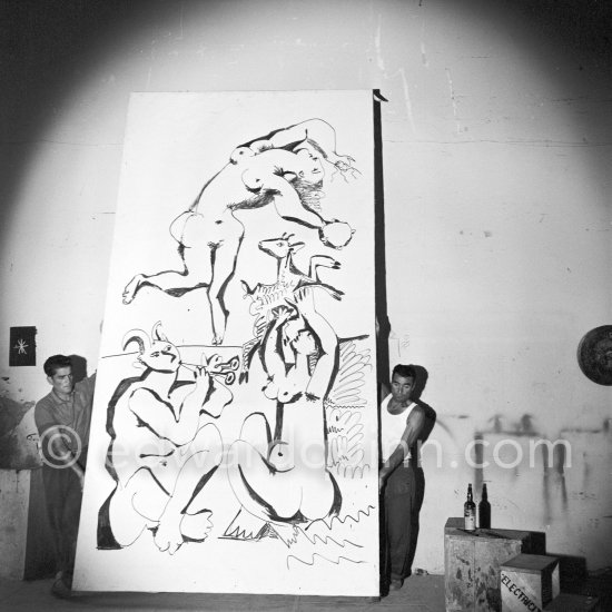 Pablo Picasso working on a bucolic pastoral scene on drawing paper which was to serve as background for the film "Le mystère Picasso". Nice, Studios de la Victorine 1955. - Photo by Edward Quinn