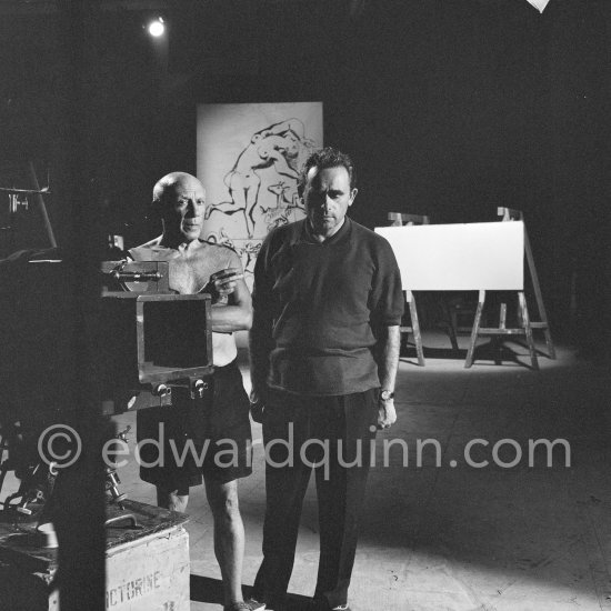 Pablo Picasso working on a bucolic pastoral scene on drawing paper which was to serve as background for the film "Le mystère Picasso". Nice, Studios de la Victorine 1955. - Photo by Edward Quinn